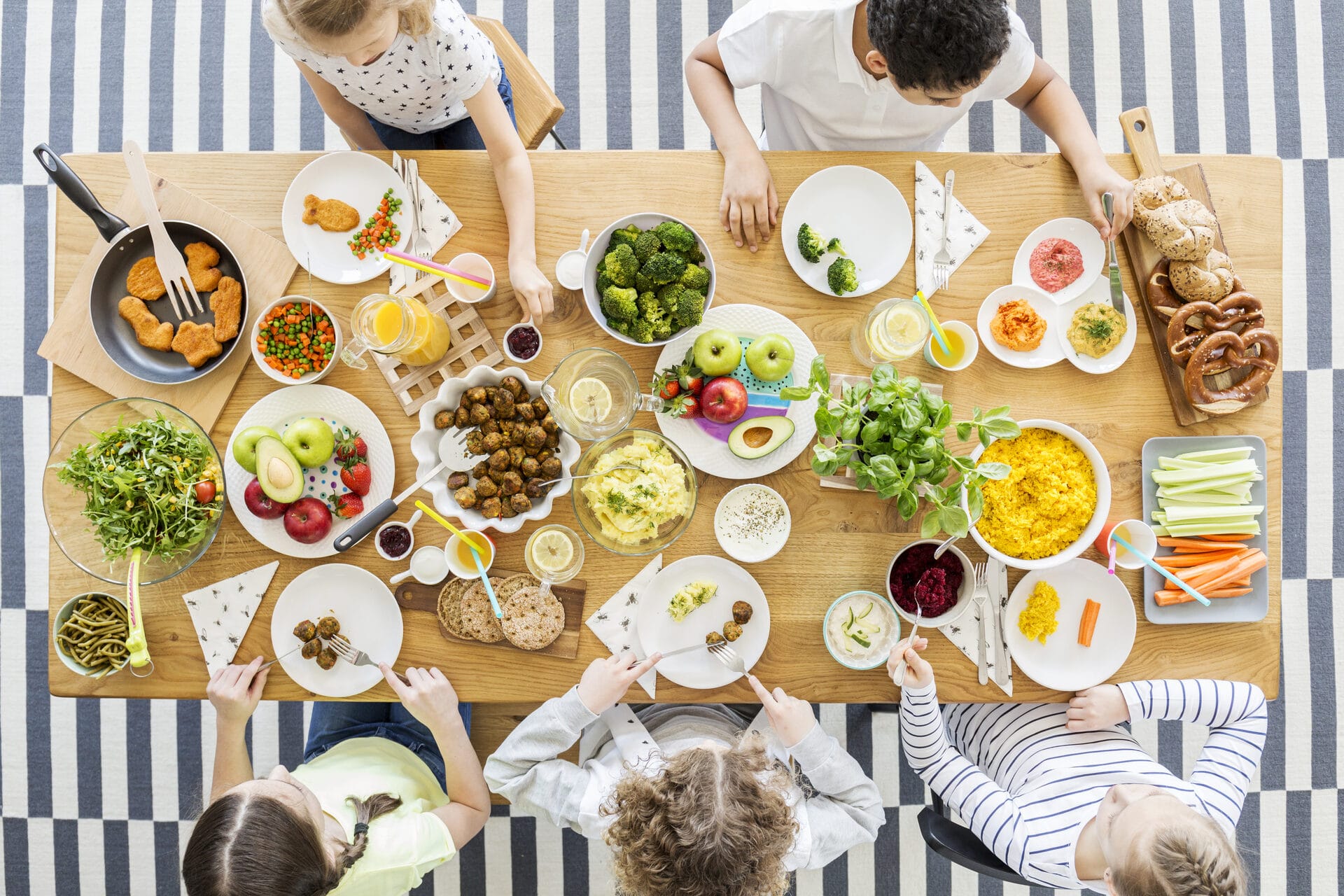 Children enjoying healthy homemade meal at table top view
